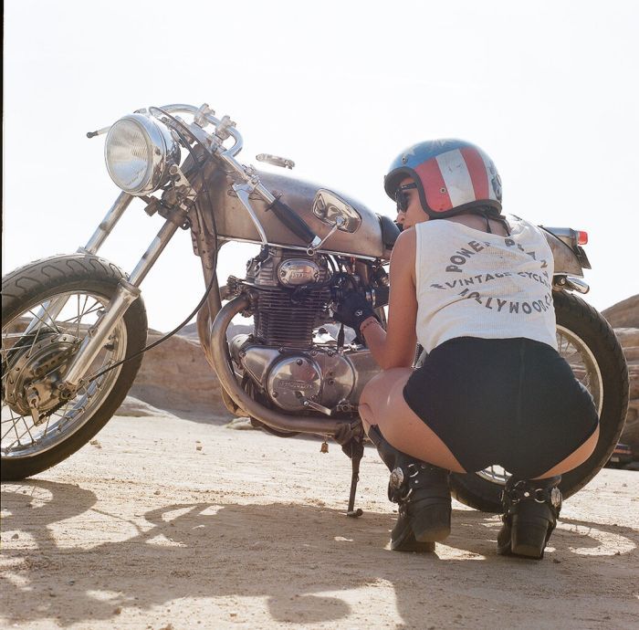 A playful frame from Girls on a motorcycle — online in Bangalore